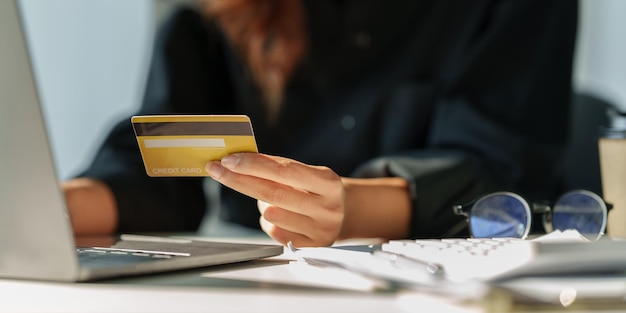 Woman using online payment and holding credit card Online Shopping concept