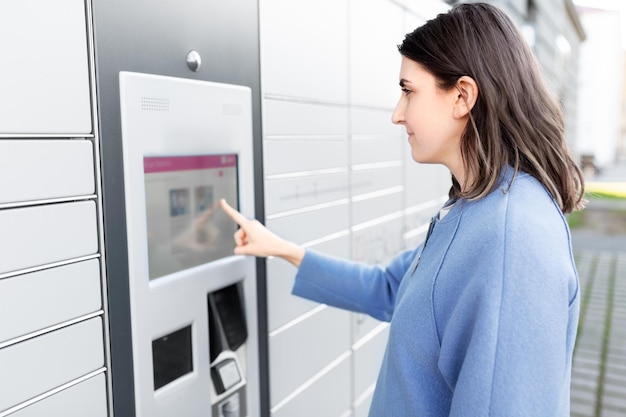 woman using outdoor automated parcel machine