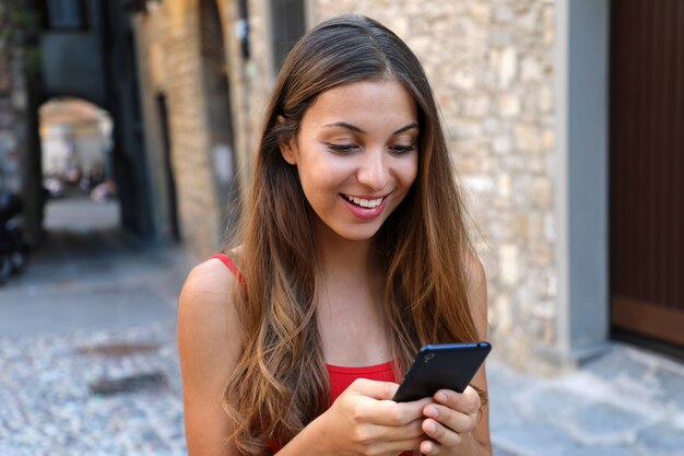 Woman using phone app to play video games online