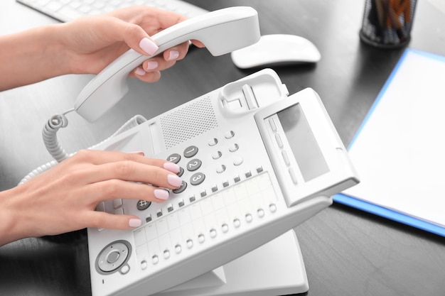 Woman using phone in office