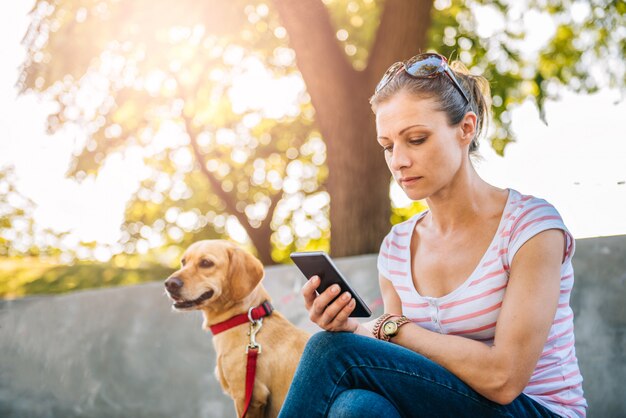 Woman using phone in the park