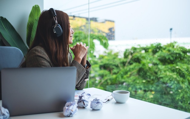 Photo woman using phone while sitting on table