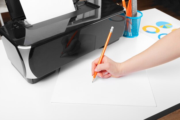 Woman using the printer to scanning and printing document