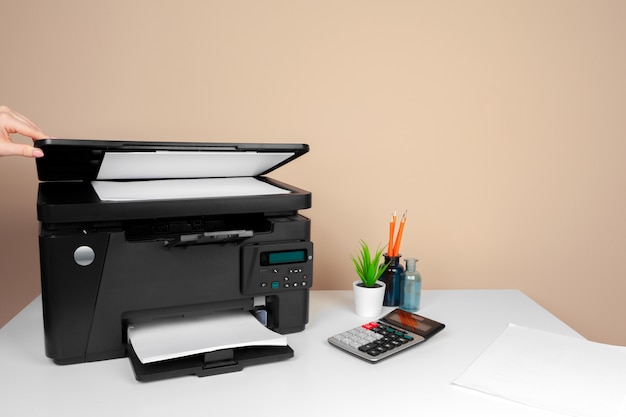 Woman using the printer to scanning and printing document