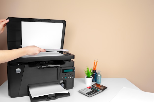 Woman using the printer to scanning and printing document