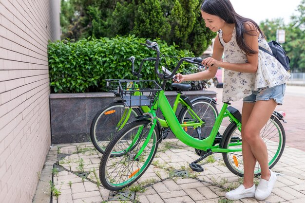 Woman using share bike in the city