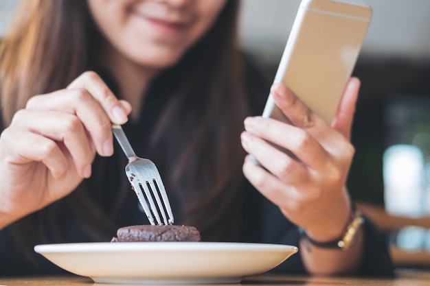 woman using smart phone while eating