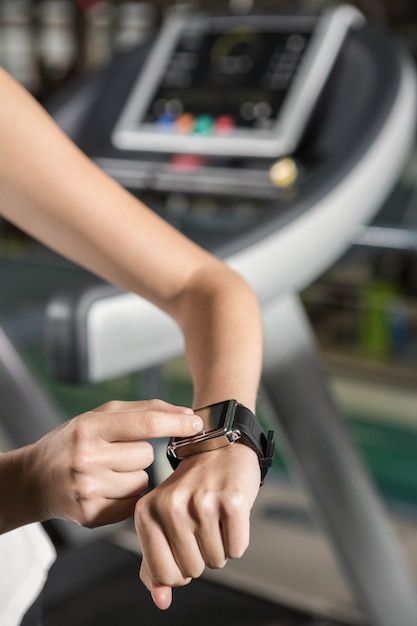 Woman using smart watch in the gym