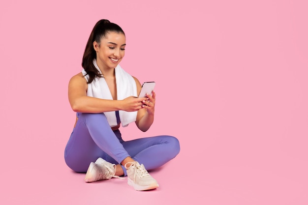 Woman using smartphone after workout session