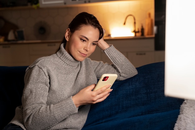 Photo woman using smartphone as a habit