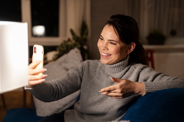 Photo woman using smartphone as a habit