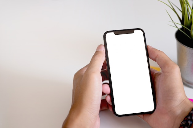 Woman using Smartphone. Blank screen mobile phone