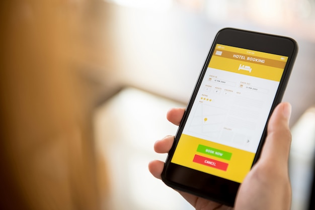 woman using smartphone booking hotel online via application