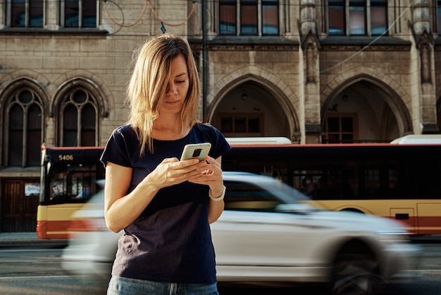 Woman using smartphone at city street