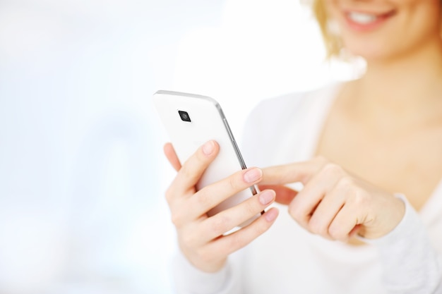 woman using smartphone at home