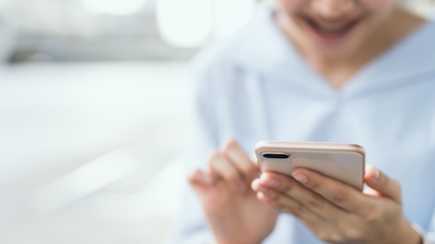 Woman using smartphone on staircase in public areas, During leisure time.