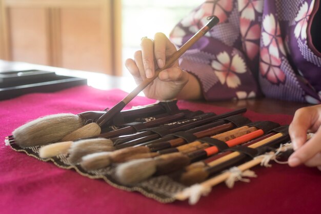 Woman using special supplies for japanese art