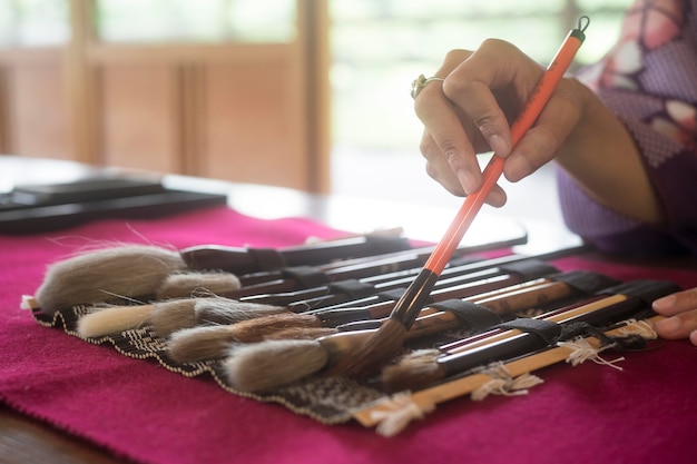 Woman using special supplies for japanese art