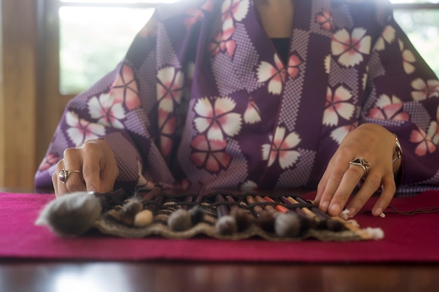 Woman using special supplies for japanese art