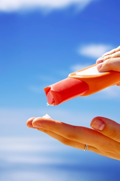 Woman using sunscreen