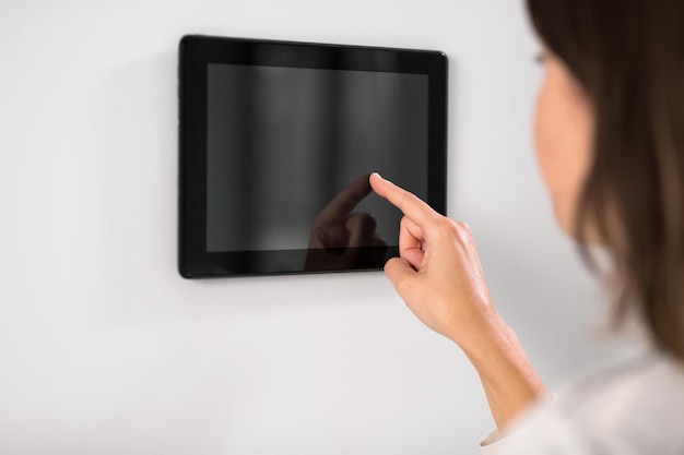woman using tablet computer at smart home