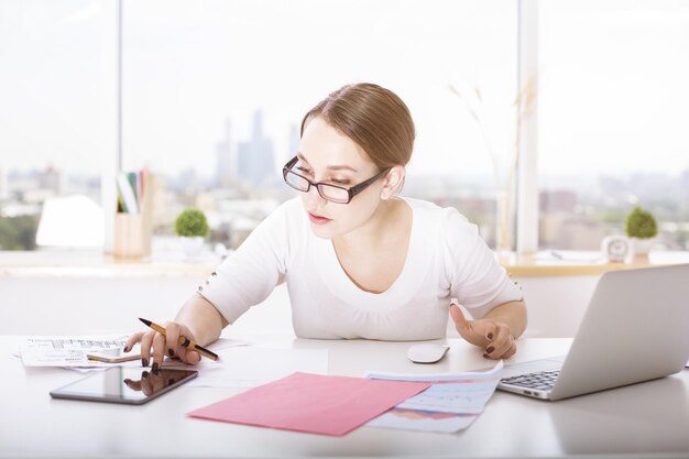 Woman using tablet at desk