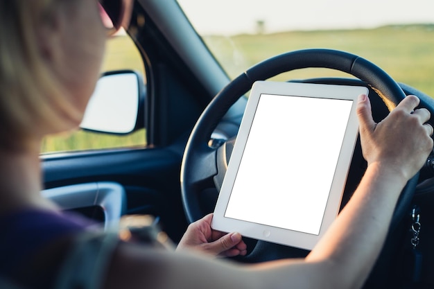 Woman using tablet pc in the car