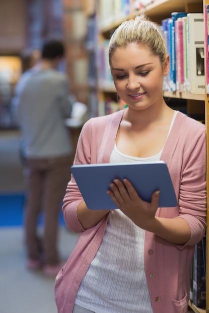 Woman using tablet pc in college library