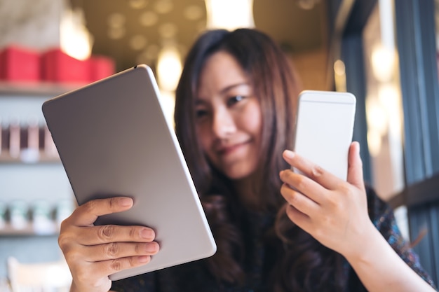 woman using tablet pc and phone