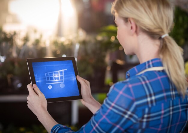 Woman using Tablet with Shopping trolley icon