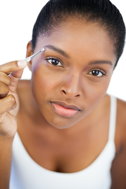 Woman using tweezers