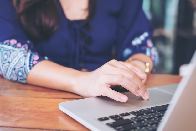 woman using and typing on laptop keyboard