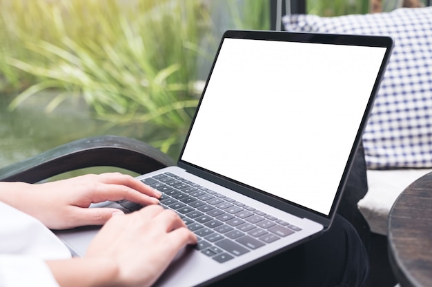 Woman using and typing on laptop