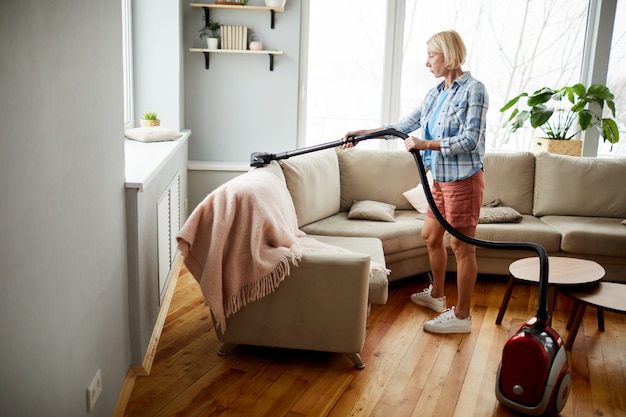 Woman using vacuum cleaner