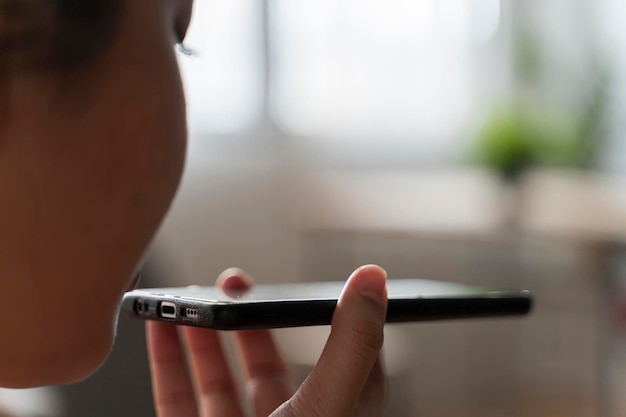 Woman using voice recognition on smart phone to record messages Woman speak and activate virtual digital voice assistant