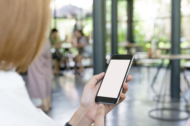 woman using white screen smartphone.