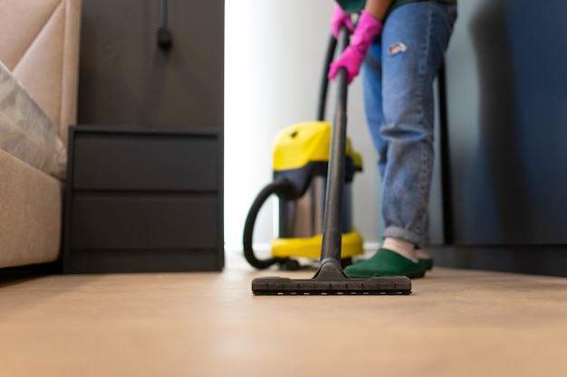 Woman vacuuming the parquet floor