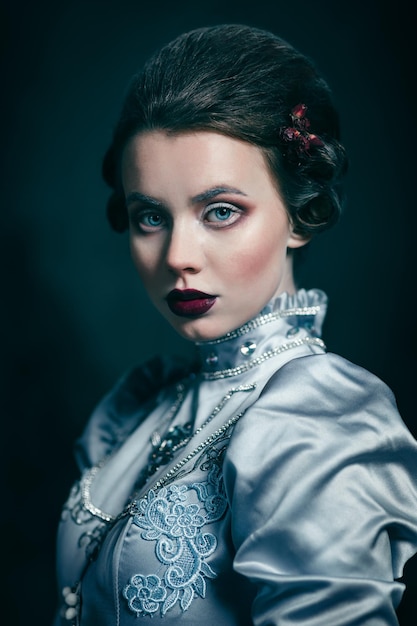 Woman in victorian dress imprisoned in a dungeon