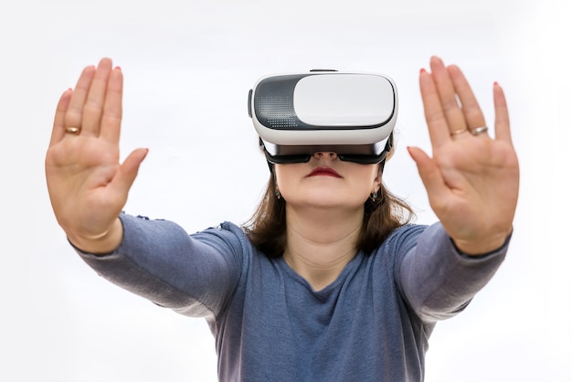 Woman in virtual glasses holding something with hands