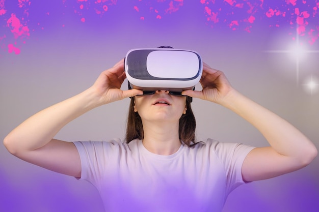 A woman in virtual reality glasses looks up