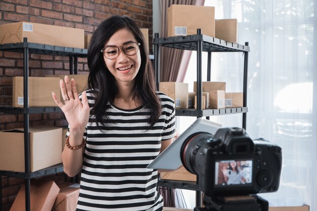 Woman vlogging in front of packages shelf