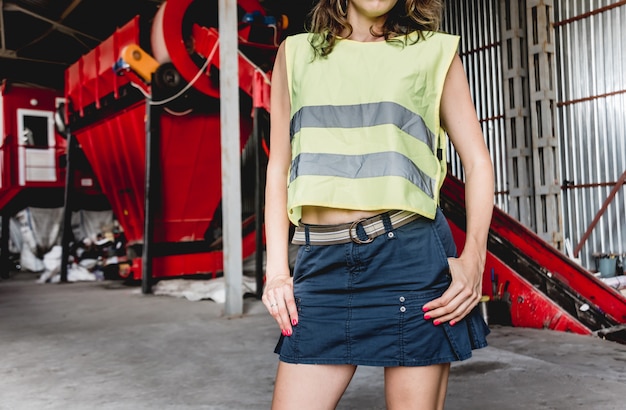 Woman-volunteer sorting trash at modern recycling plant.