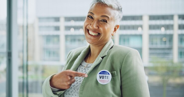 Photo woman vote and portrait for politics pointing and badge for support government and member elections voter choice and representative for democracy registration and sticker for voting register