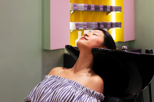 Woman waits in the hairdressing to wash her hair