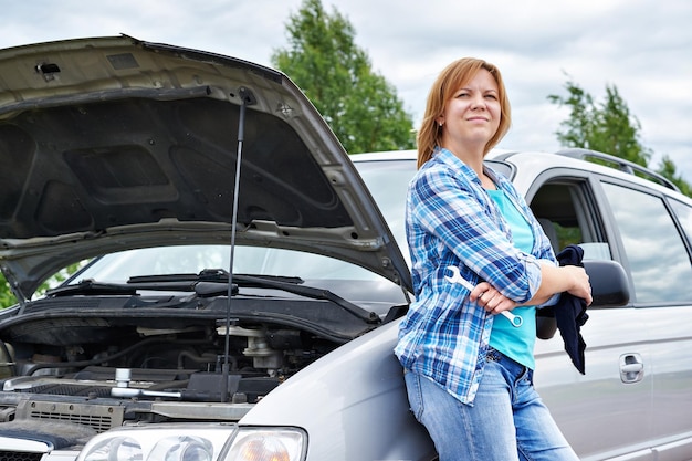 Woman waits help near broken car