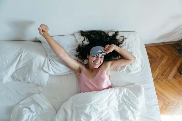 woman waking at the bright morning sleeping mask