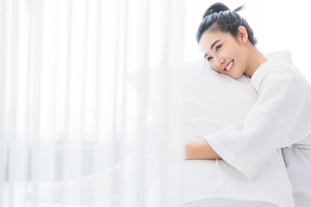 woman waking up in her bed.  