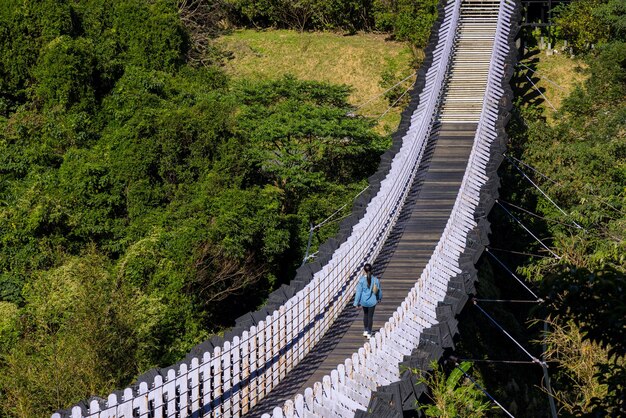 Woman walk along the suspension bridge