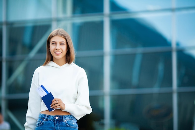 Photo woman walk near airport with suitcase passport and passenger ticket