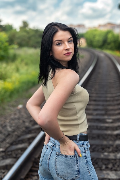 Woman walk on the railroad tracks, summer lifestyle trip